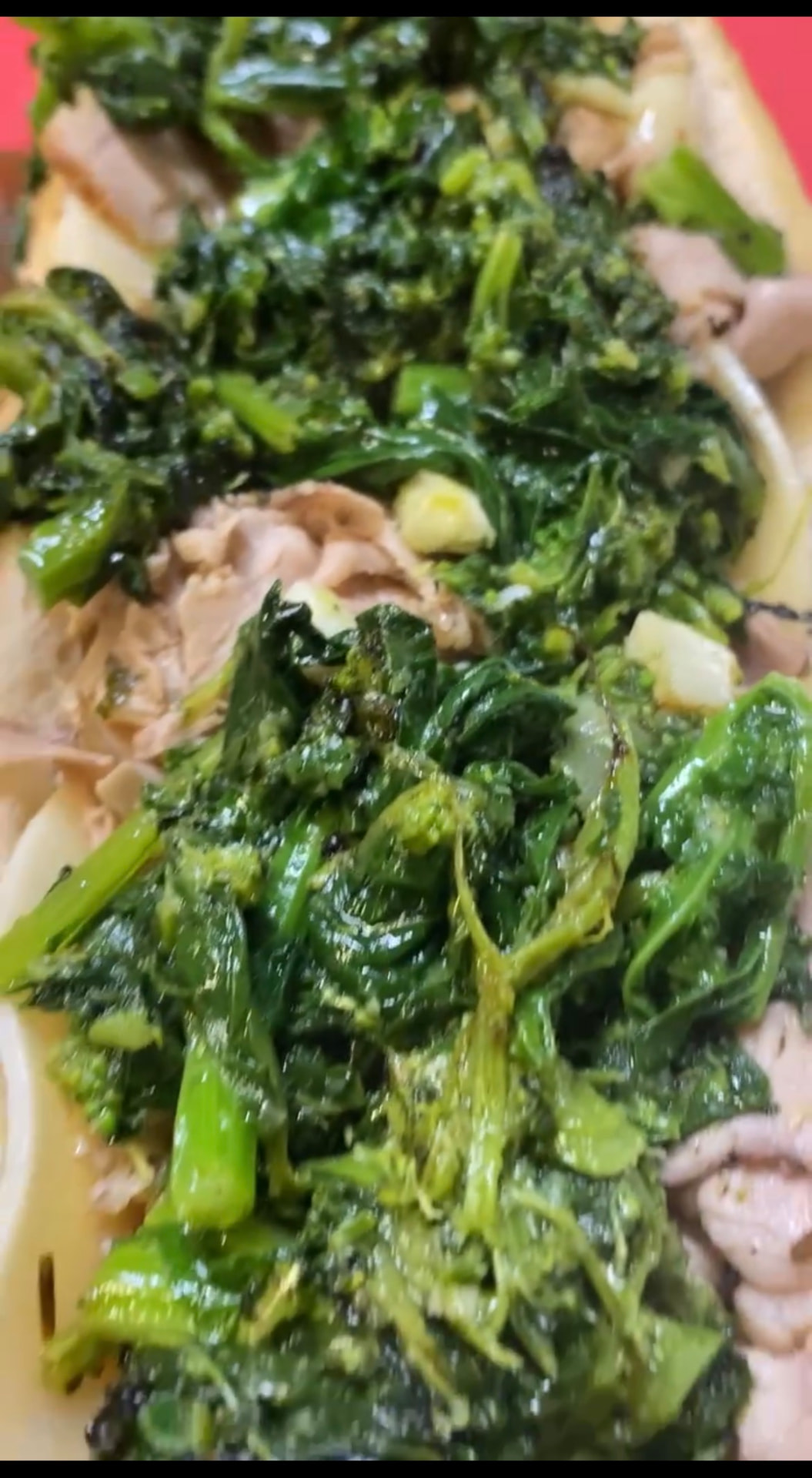 Roast pork sandwich on a long roll loaded with sliced pork, provolone and garlicky broccoli rabe